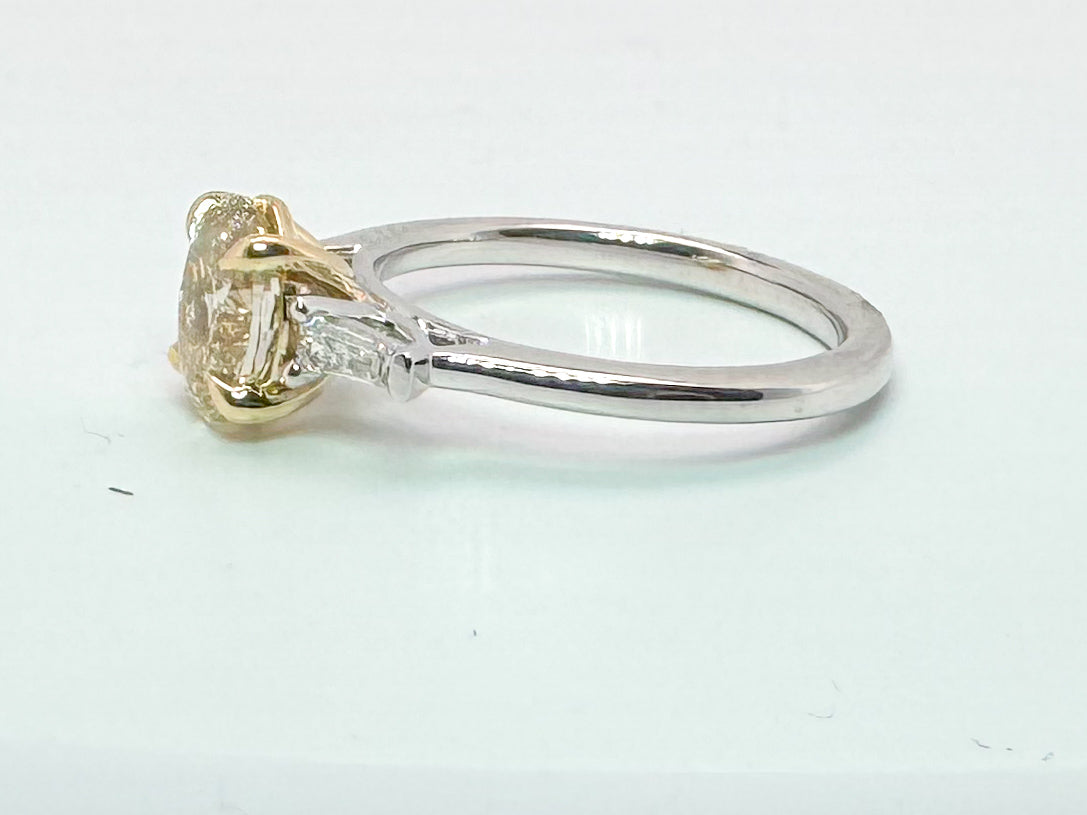 14k two tone 1.52 VS2 Fancy yellow lab grown oval set with .19 baguettes.