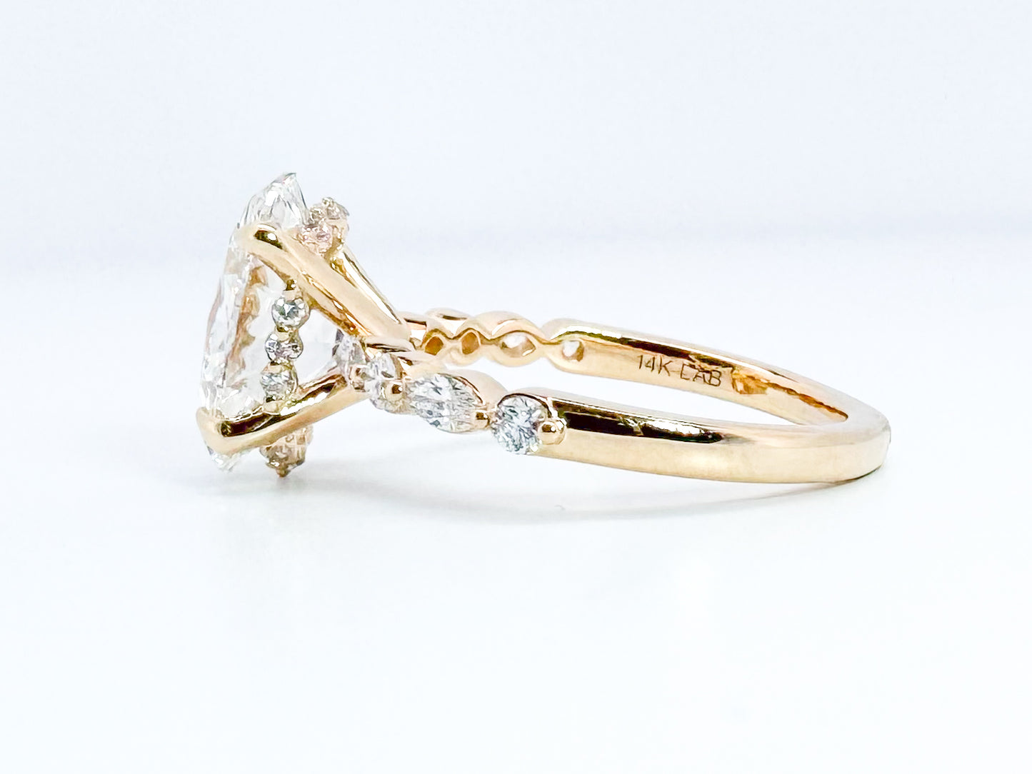 14K, 3.08 VVS2 E Lab grown oval set with .33 side diamonds. IGI Certified