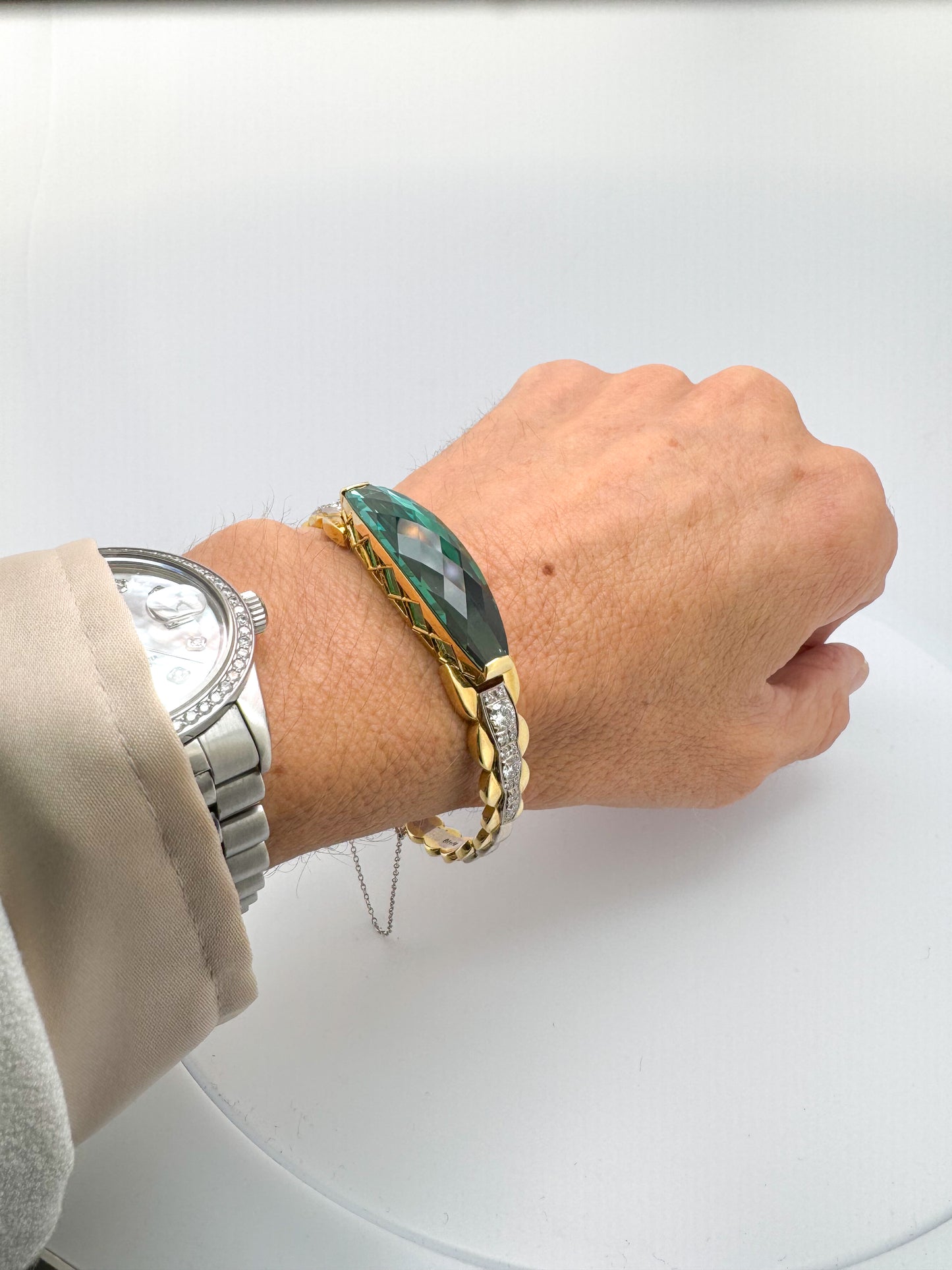 18k two tone, custom cut 26.4 carat blue green Tourmaline with 1.44 carat total weight in side diamonds.