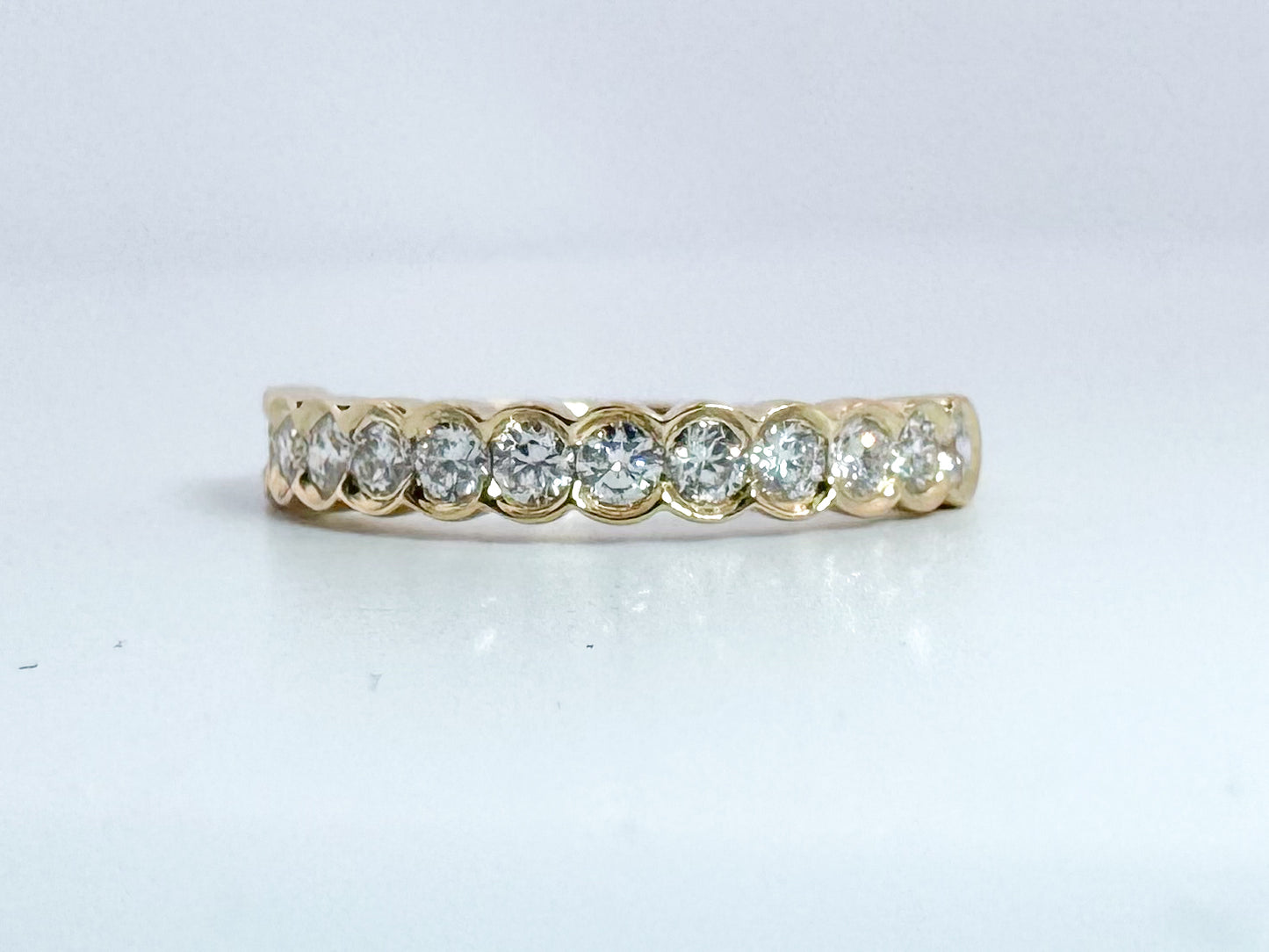 14k, Yellow gold .50 dtw half bezel diamond band.