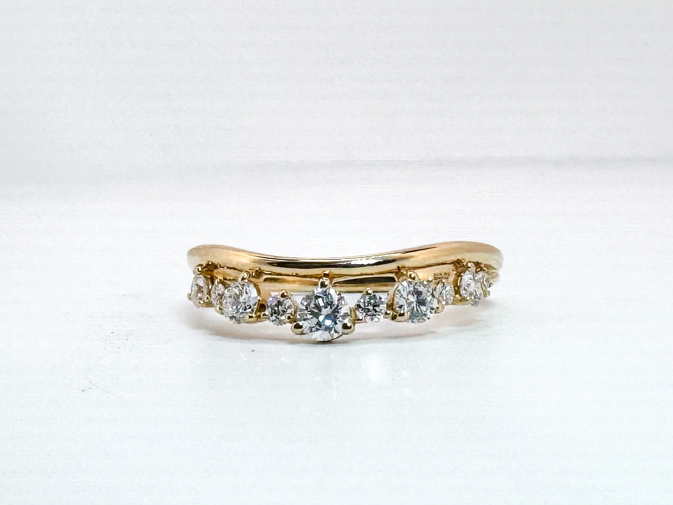 14k, yellow gold.40 diamond total weight, curved wedding band.