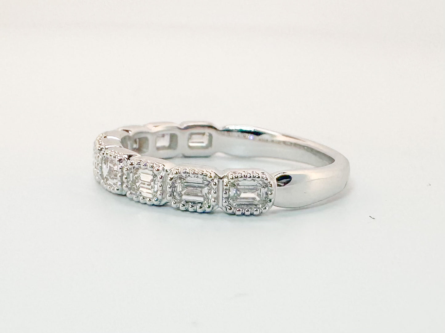 14K, White gold .75 carat. East/West, emerald cut natural diamonds VS G