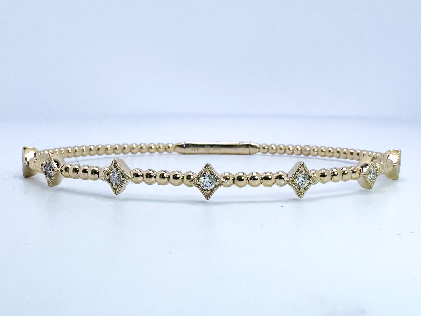 14k, yellow gold diamond bangle .31 diamond total weight.