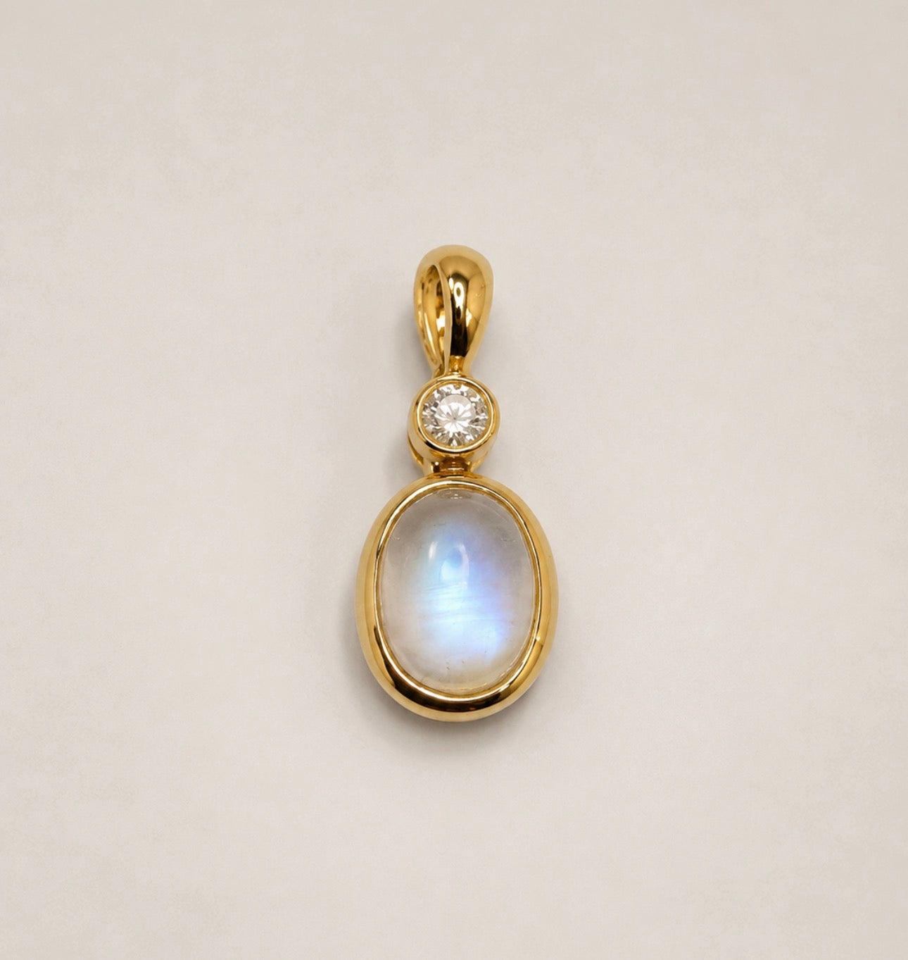 14ky .08 carat total weight, 1.27 ct moon stone and natural diamond pendant.