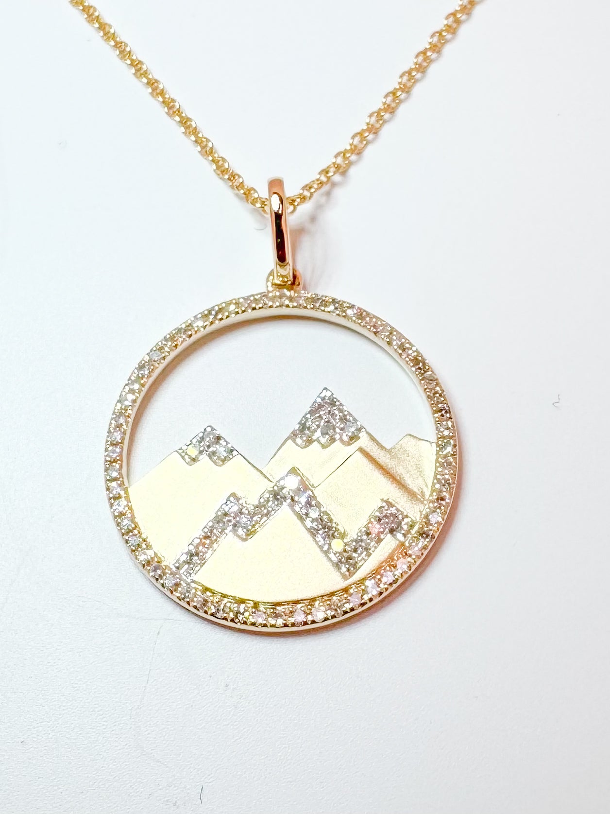 14K,, Yellow gold, .21 diamond total weight, framed mountain scene pendant.