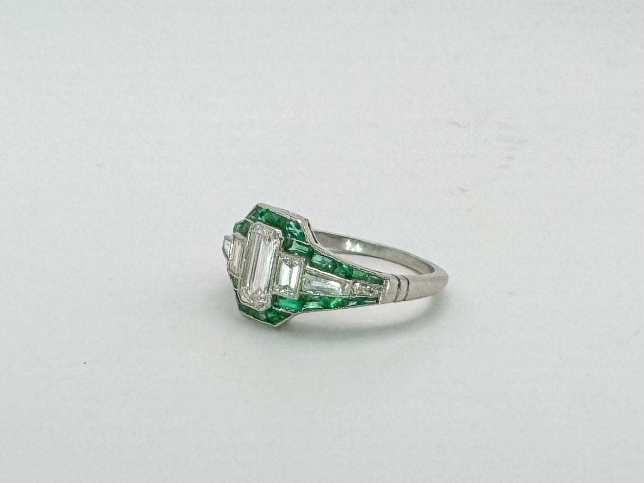 VINTAGE, Platinum .58 Natural emerald cut diamond set with .38 side diamonds and Natural Emeralds