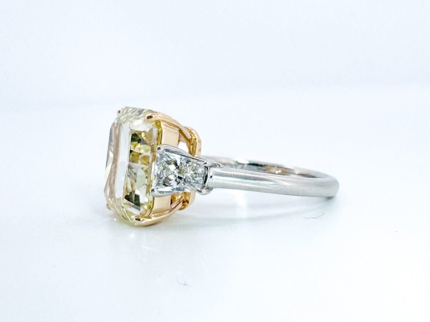 6.07 Natural Fancy light yellow, VS1 , Set in Platinum and 18k with 1.00 carat of side diamond trapezoids.