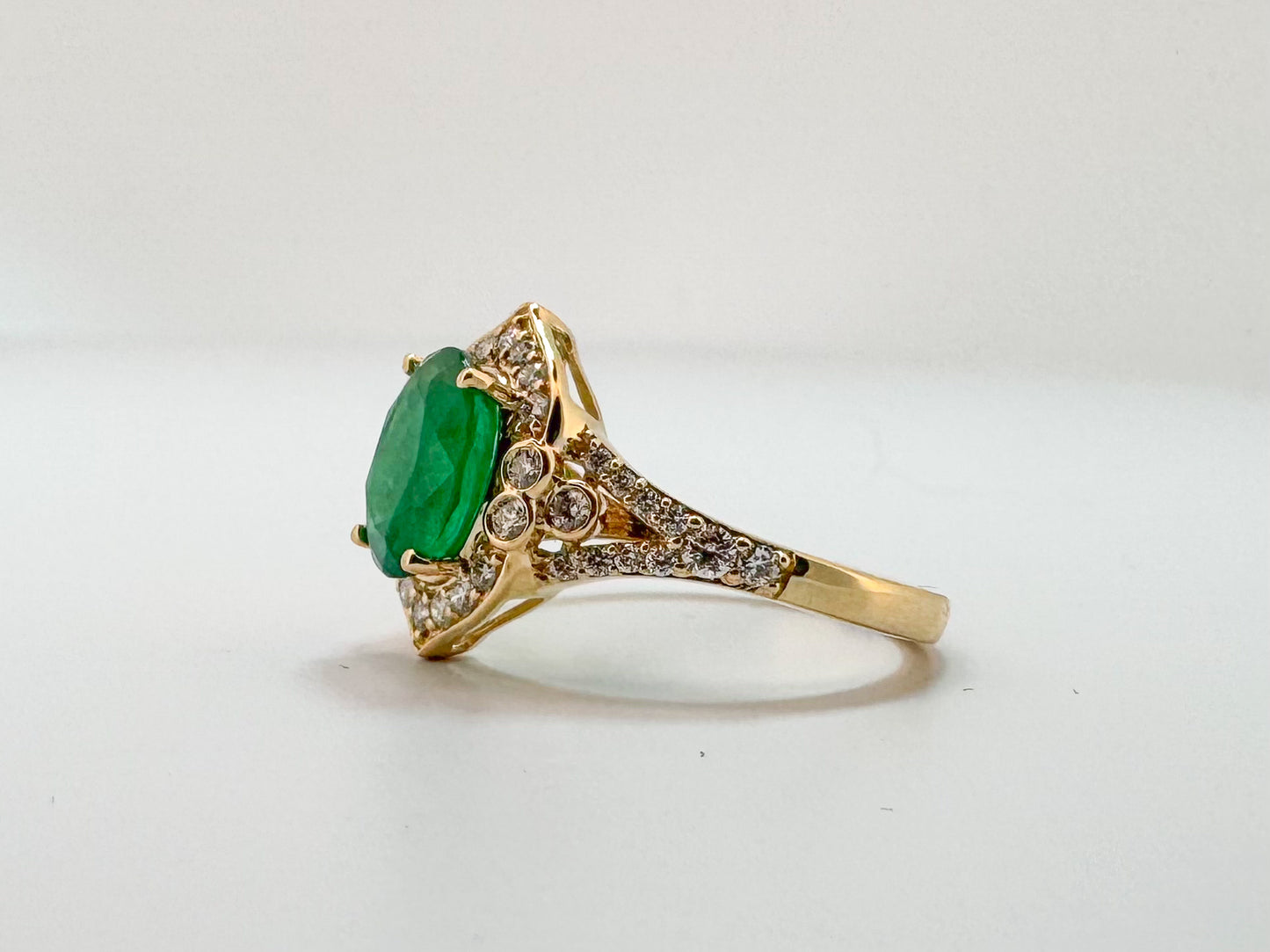 14K, yellow gold, 1.75 carat natural emerald, set with .40 carats of natural side diamonds.