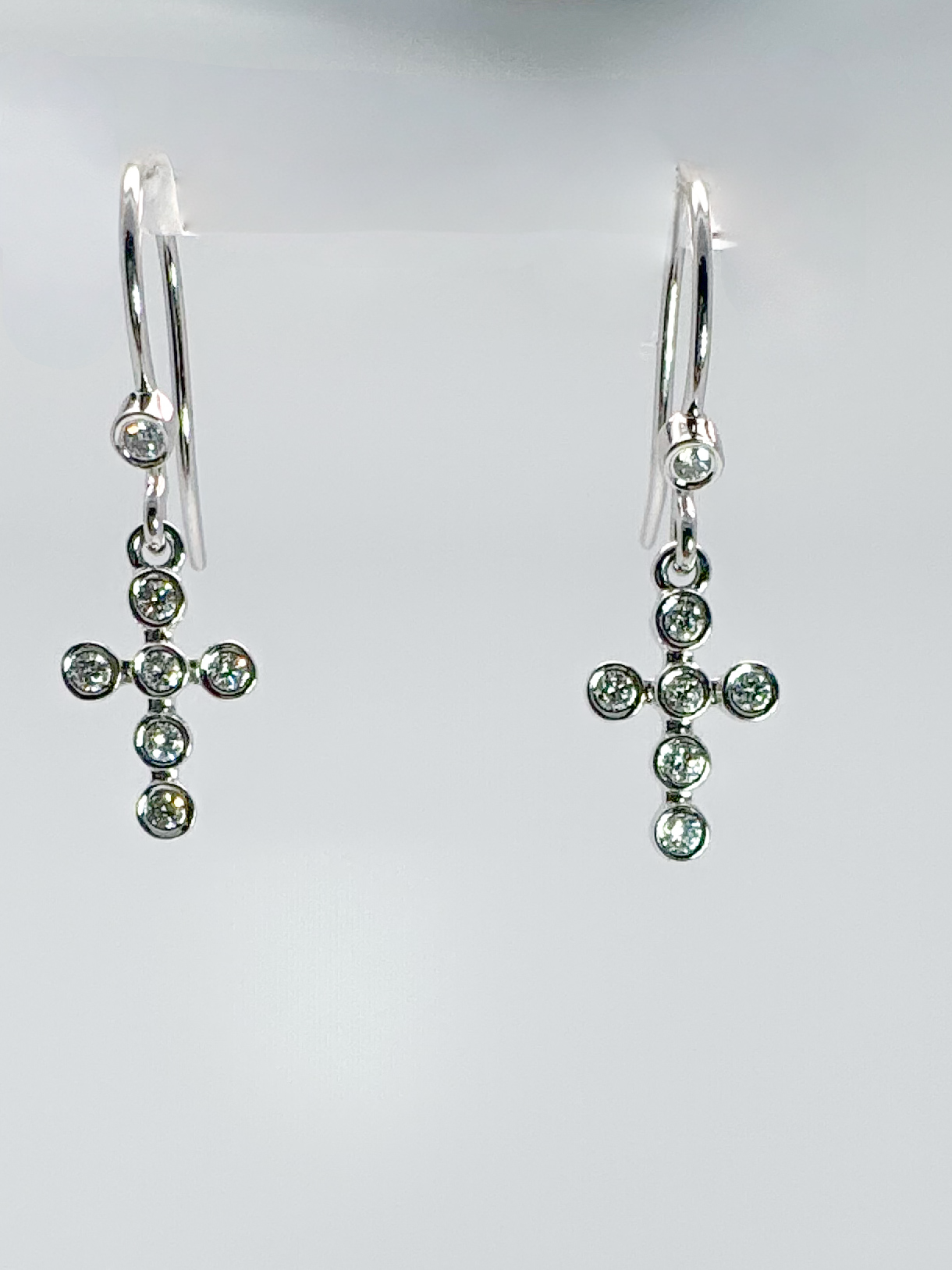 14kw .20 bezel set natural diamond cross earrings.