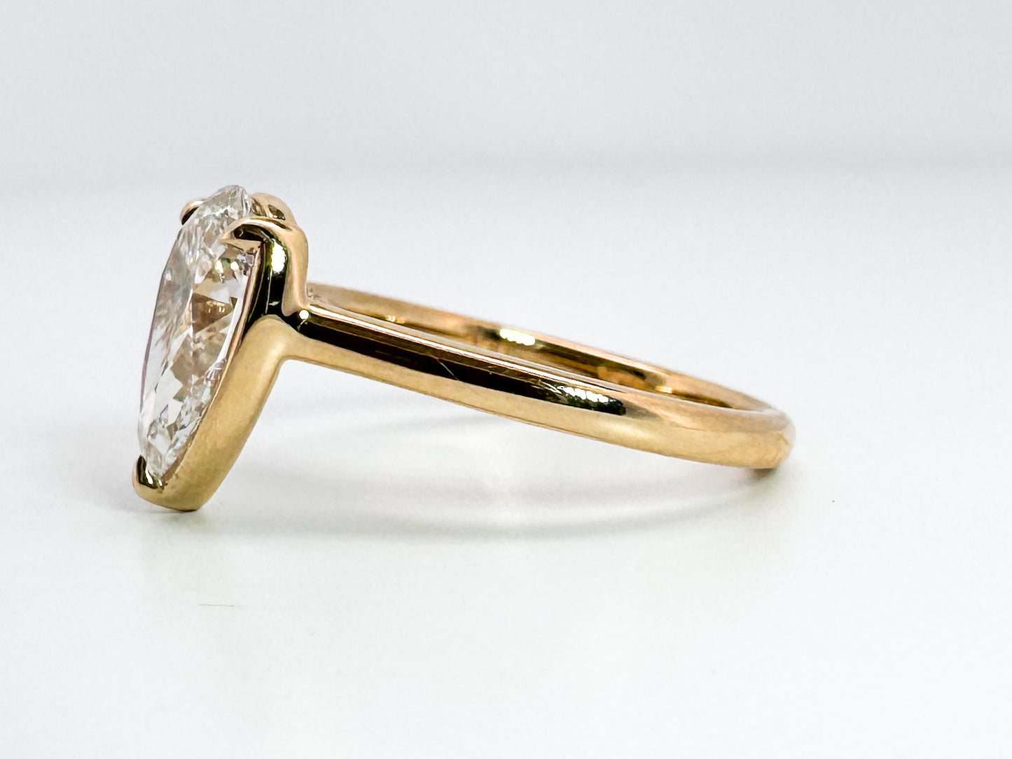 14K, Yellow gold 2.01 VS1 F pear shaped lab grown diamond with .10 side diamonds. IGI certified