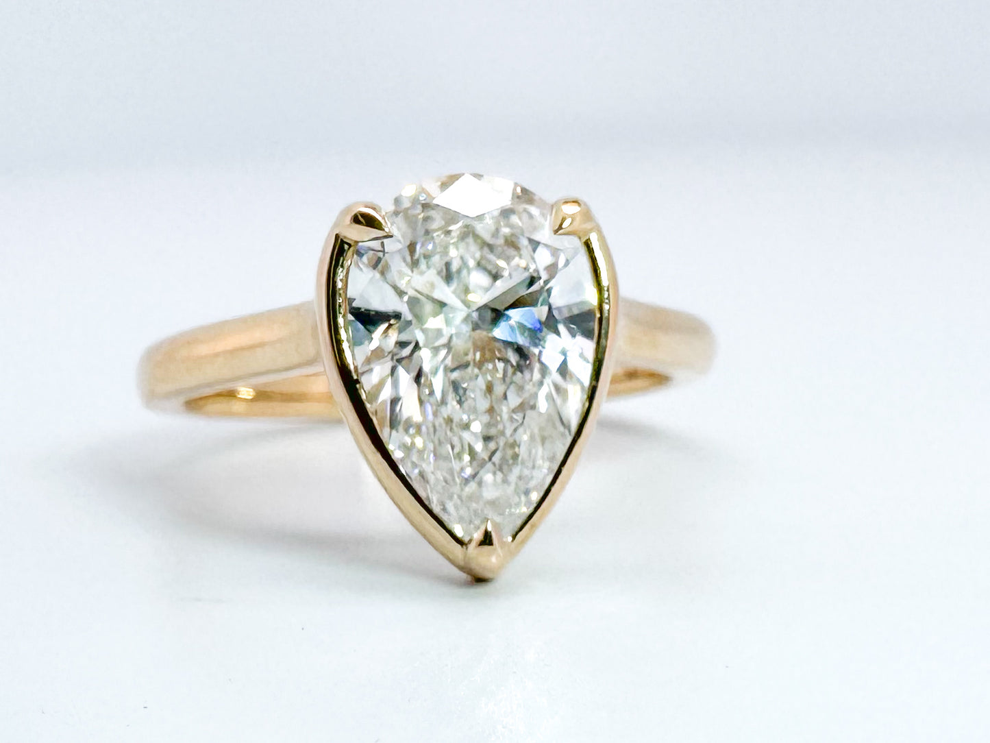 14K, Yellow gold 2.01 VS1 F pear shaped lab grown diamond with .10 side diamonds. IGI certified