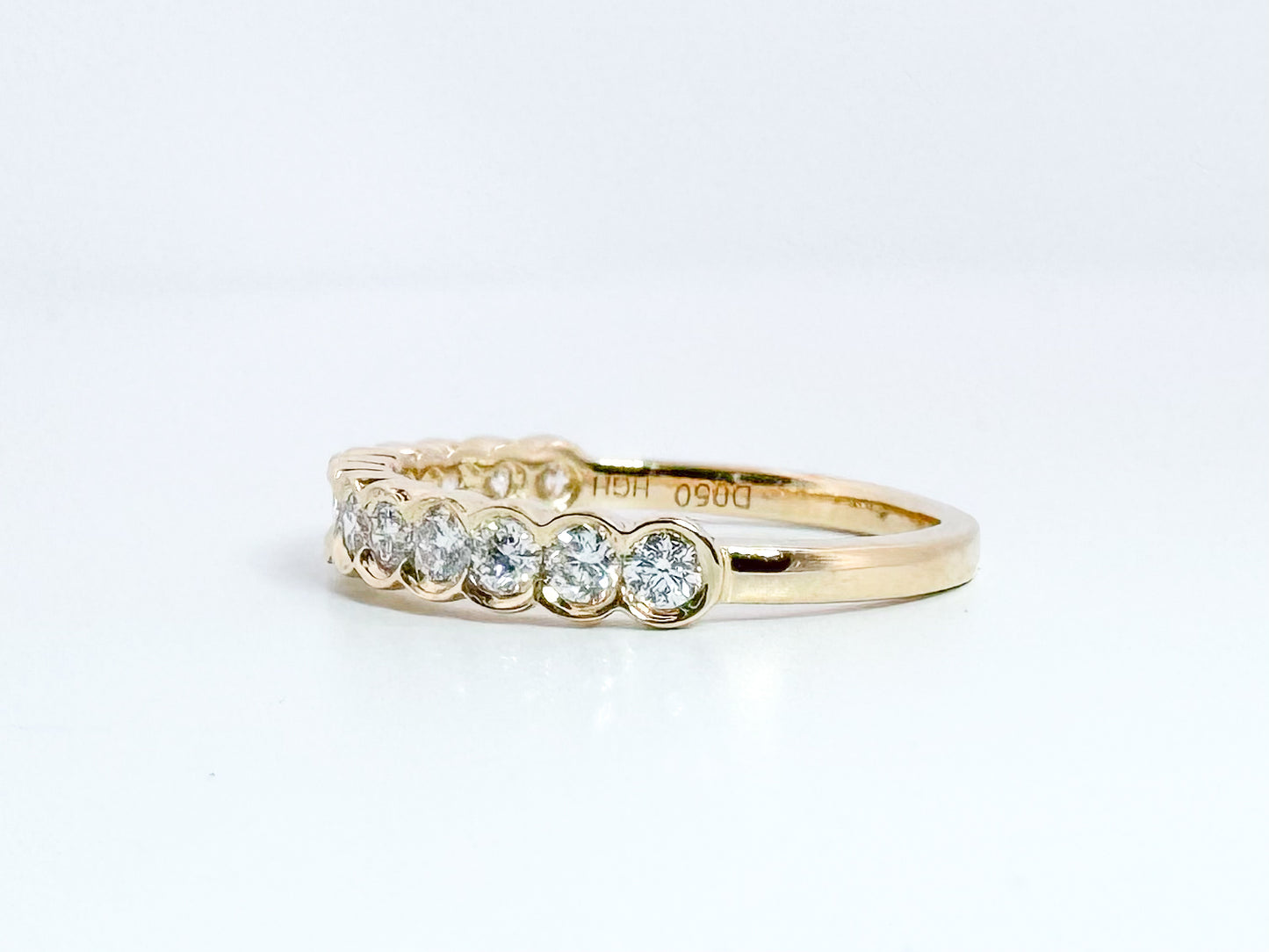 14k, Yellow gold .50 dtw half bezel diamond band.