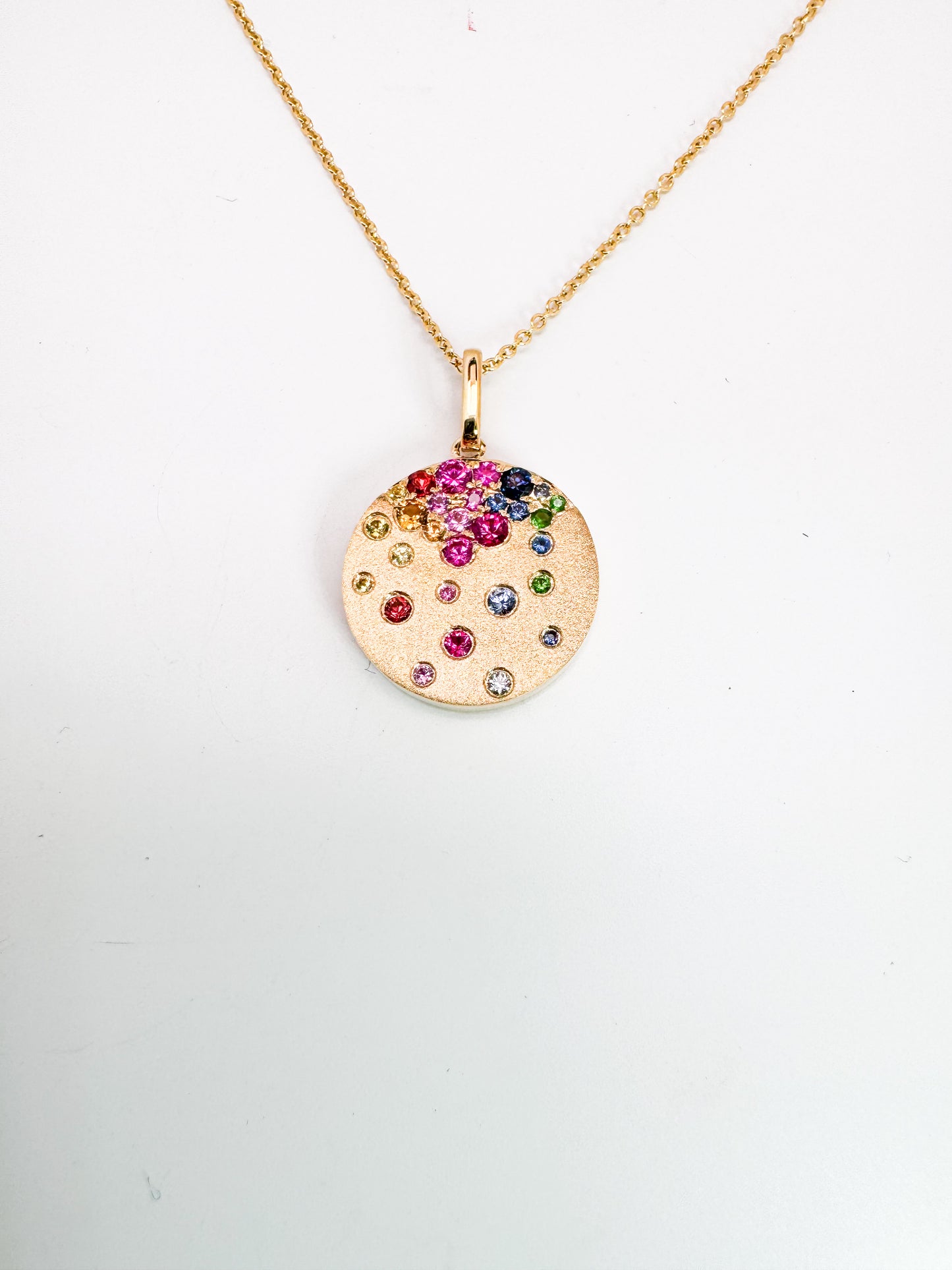 14K,Yellow gold, rainbow sapphire, ruby and tsavorite garnet sparkle penant and chain.