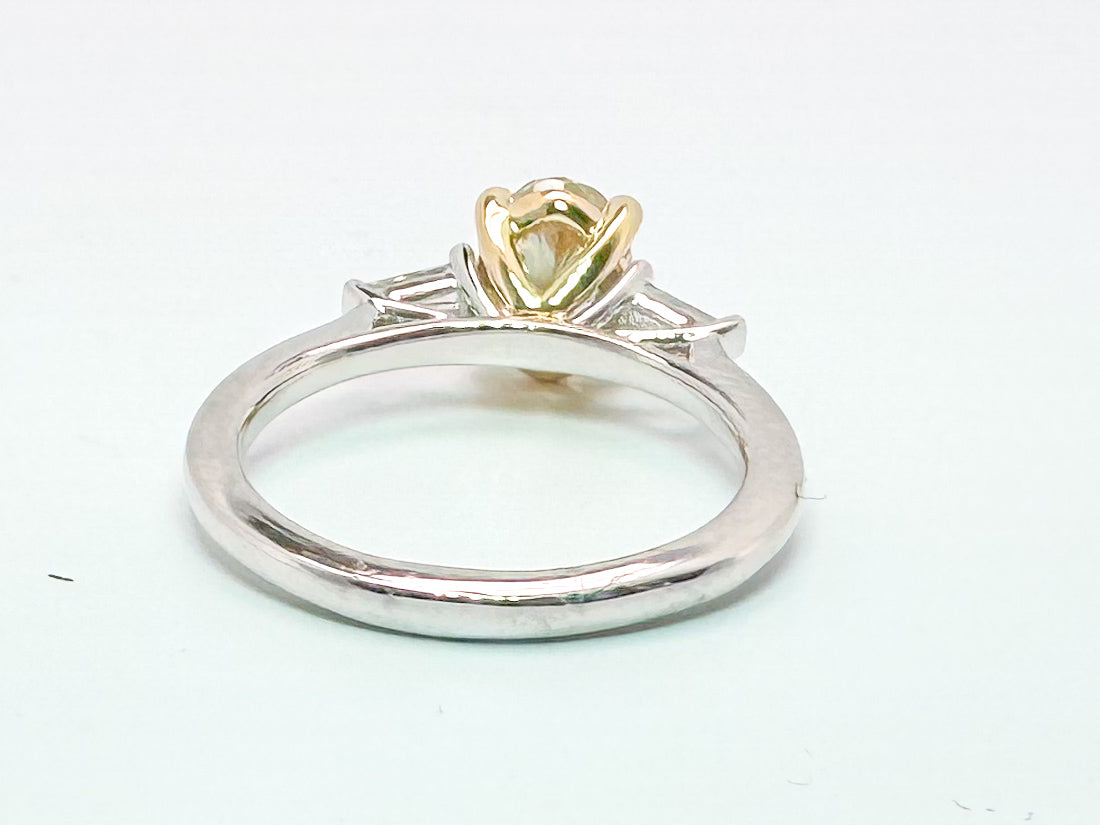 14k two tone 1.52 VS2 Fancy yellow lab grown oval set with .19 baguettes.
