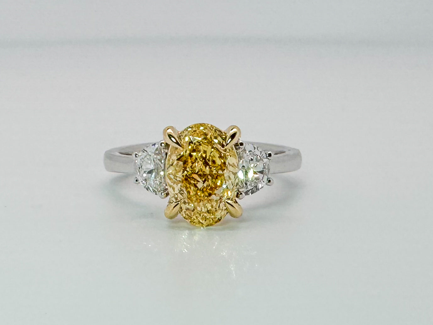 14K two tone 2.01 VS2 Fancy vivid yellow set with .45 side diamonds. Lab grown diamond engagement ring