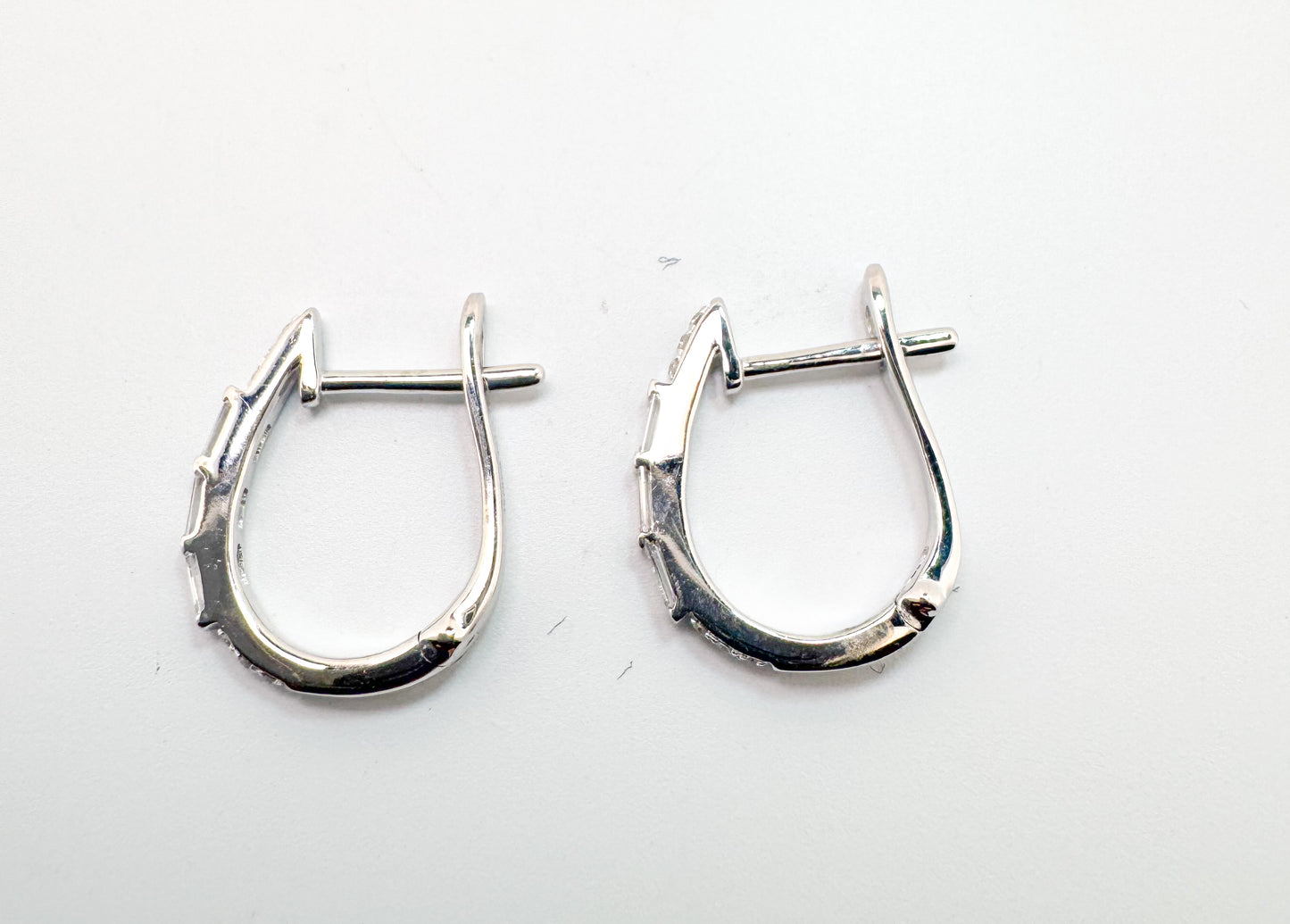 14k, white gold, round brilliant and baguette diamond hoop earrings.