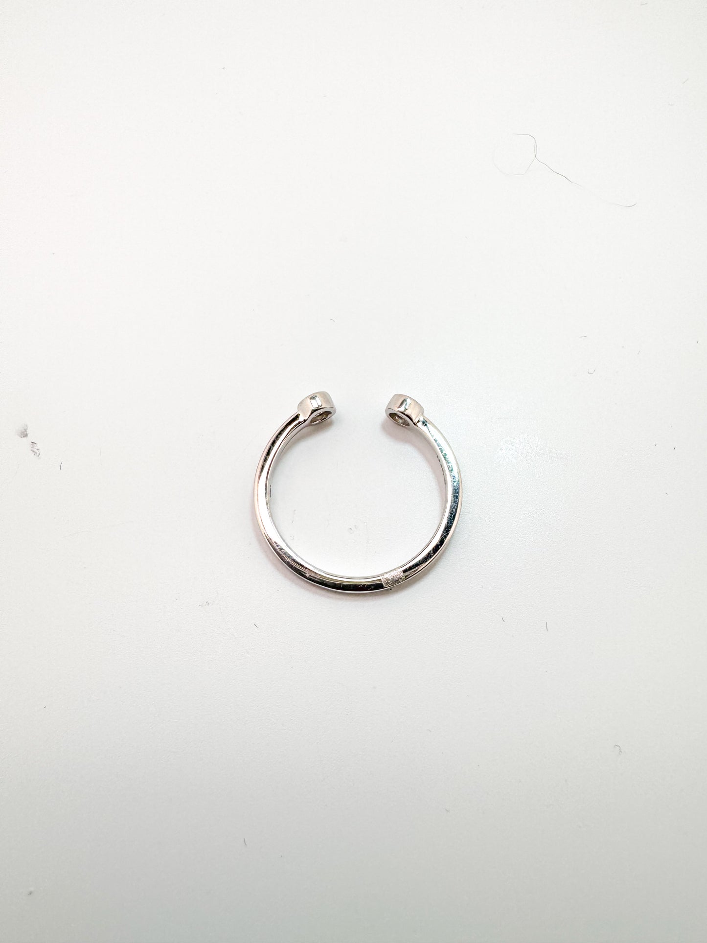 14k, white gold, open concept two diamond ring. .10 carat total weight.