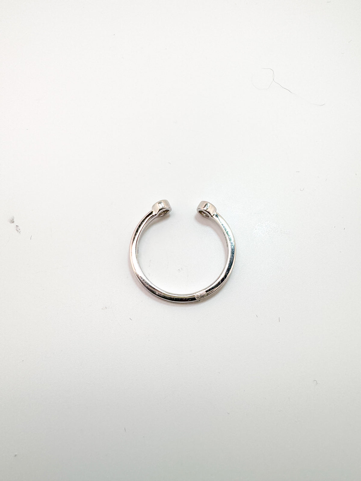 14k, white gold, open concept two diamond ring. .10 carat total weight.