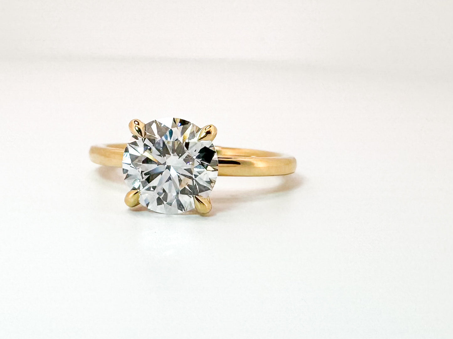 14K, Yellow gold 2.09 carat Ideal cut, round brilliant, set with .08 hidden halo side diamond. IGI certified