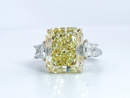 6.07 Natural Fancy light yellow, VS1 , Set in Platinum and 18k with 1.00 carat of side diamond trapezoids.