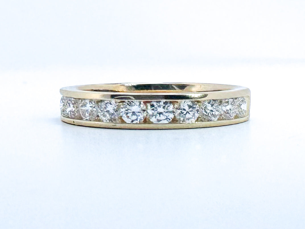 14k, yellow gold channel set natural diamond anniversary band. .75 carat total weight