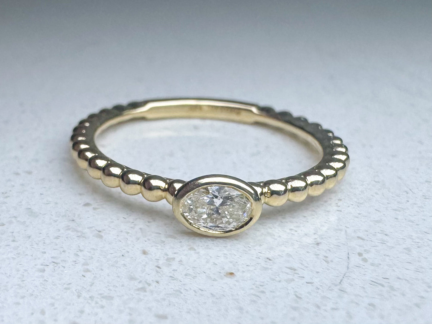 14k yellow gold .20ctw side ways oval diamond beaded fashion/ stack ring