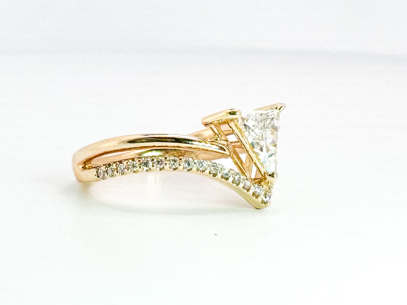 14k yellow gold natural .52 carat trillion diamond set with .16 side damonds