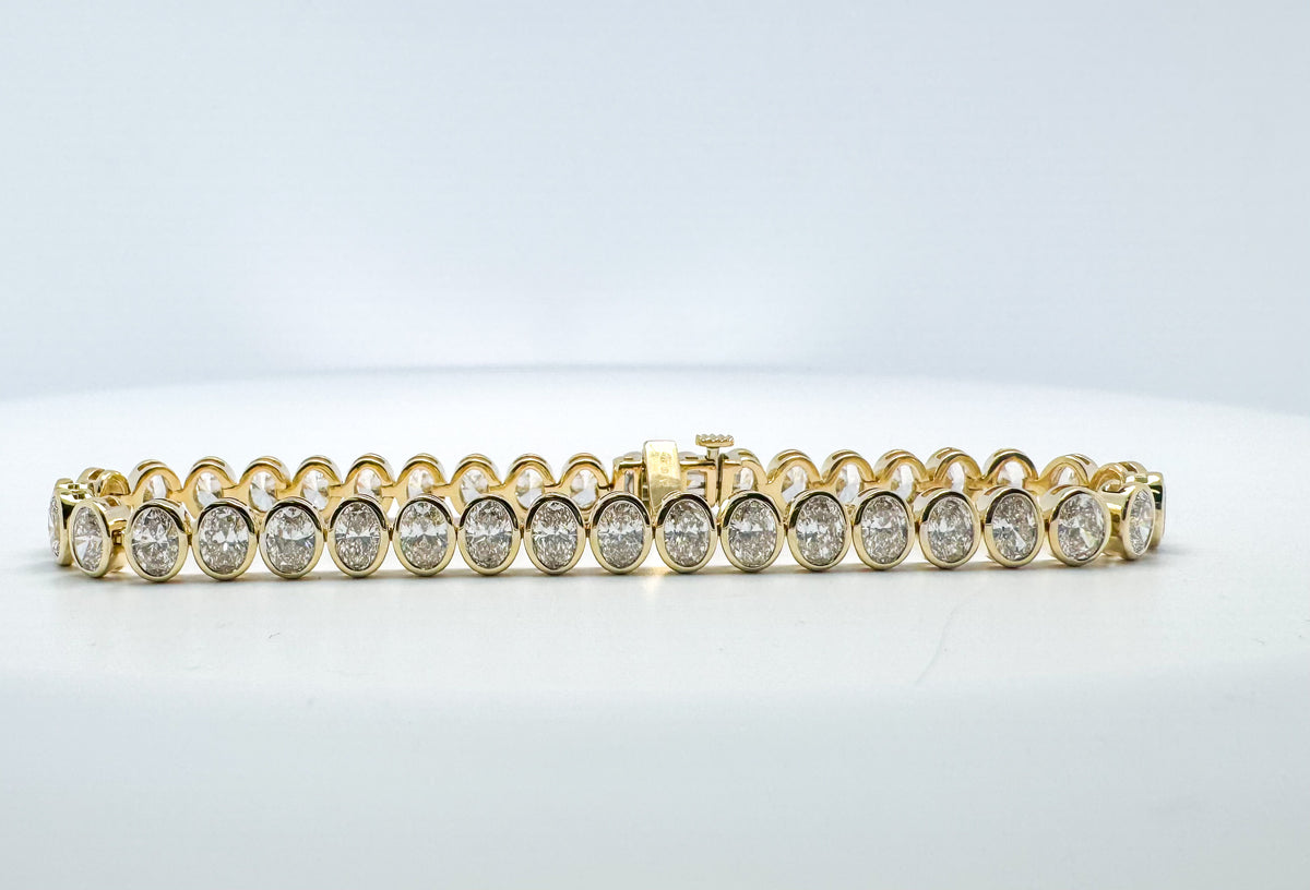 14K, Yellow gold, bezel set lab grown diamond tennis bracelet. 7.70 carat total weight