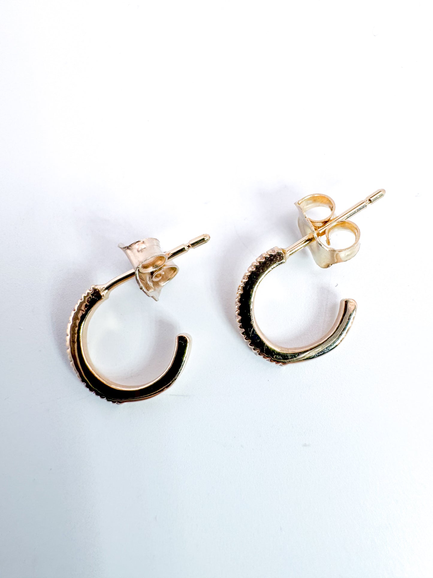 14K, yellow gold .10 diamond total weight, huggie earrings.