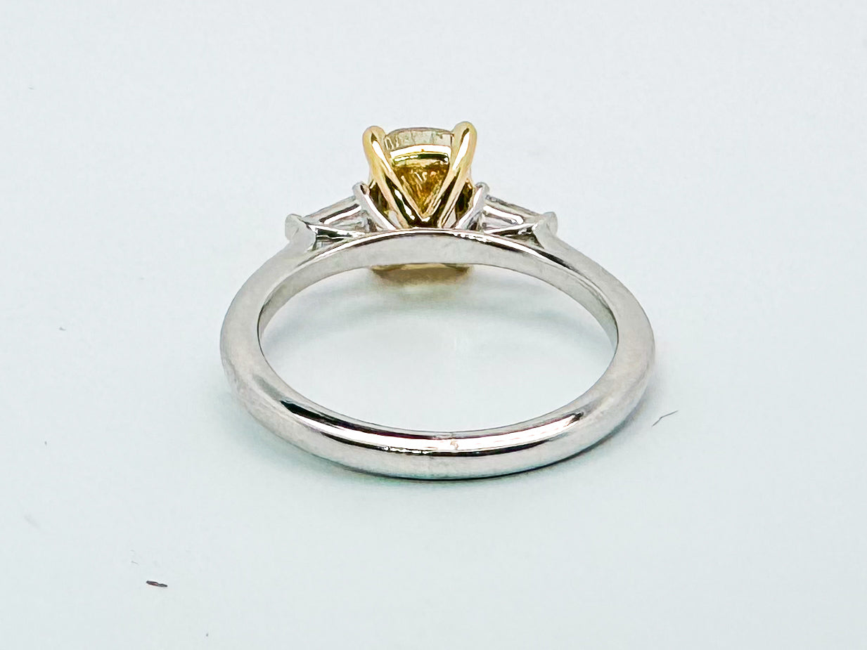 14K two tone 1.62 VS2 fancy intense yellow set with .09 total weight baguettes. Lab grown