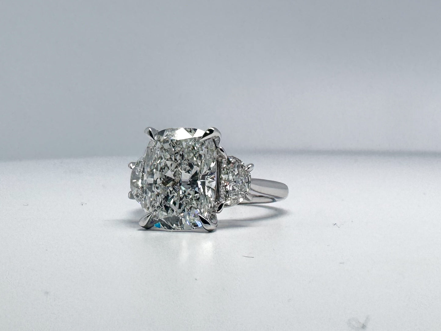 5.18 carat, Lab grown cushion cut diamond set with .82 half moon side diamonds