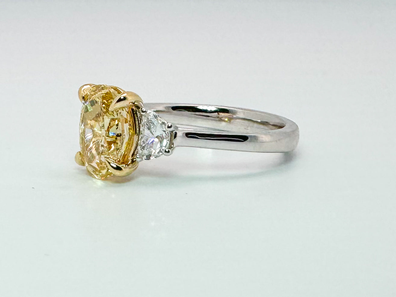 14K two tone 2.01 VS2 Fancy vivid yellow set with .45 side diamonds. Lab grown diamond engagement ring
