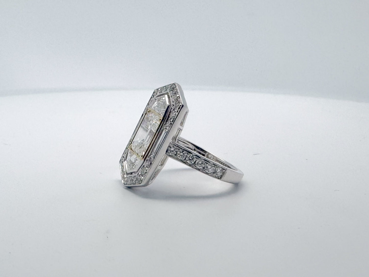 2.05 Natural VS1 E Emerald cut diamond set in classic diamond hidden halo engagemet ring. GIA certified