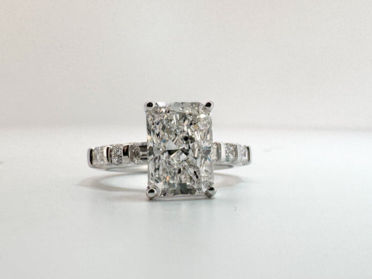 3.05 VS1 E, lab grown radiant cut diamond, set with .87 carats of side diamonds. IGI certified