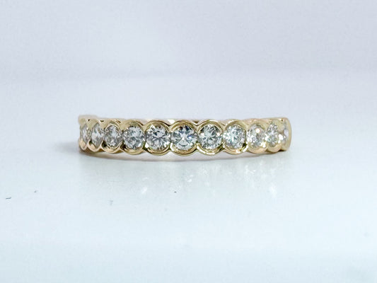 14k, Yellow gold .50 dtw half bezel diamond band.