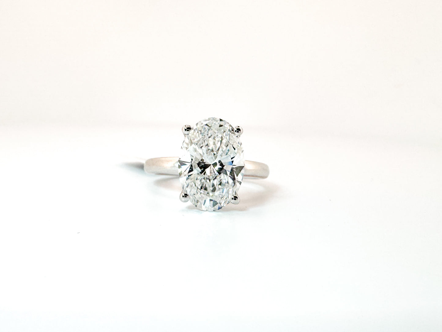 14k, White gold solitaire, set with 4.02 carat lab grown oval diamond. GIA Certified. VS1 E
