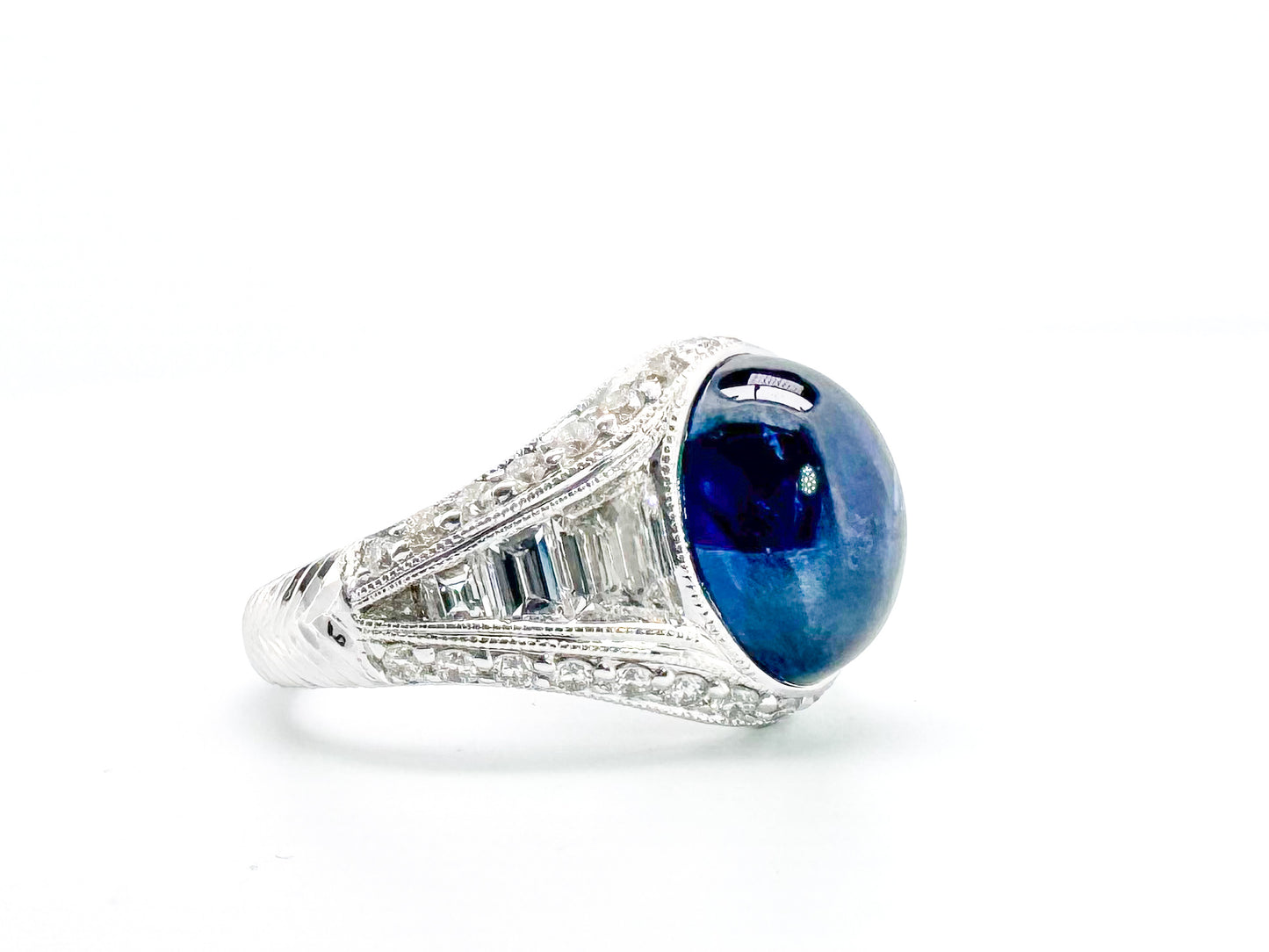 6.27 Carat, natural cabochon sapphire, set in custom hand engraved, 1.60 diamond total weight mounting.