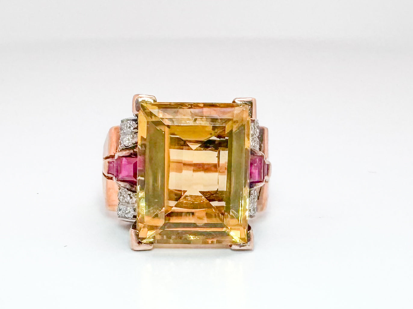 Platinum & 18k, Rose gold retro ring. 12.0 carat citrine, with .32 dtw flanked with syn ruby.