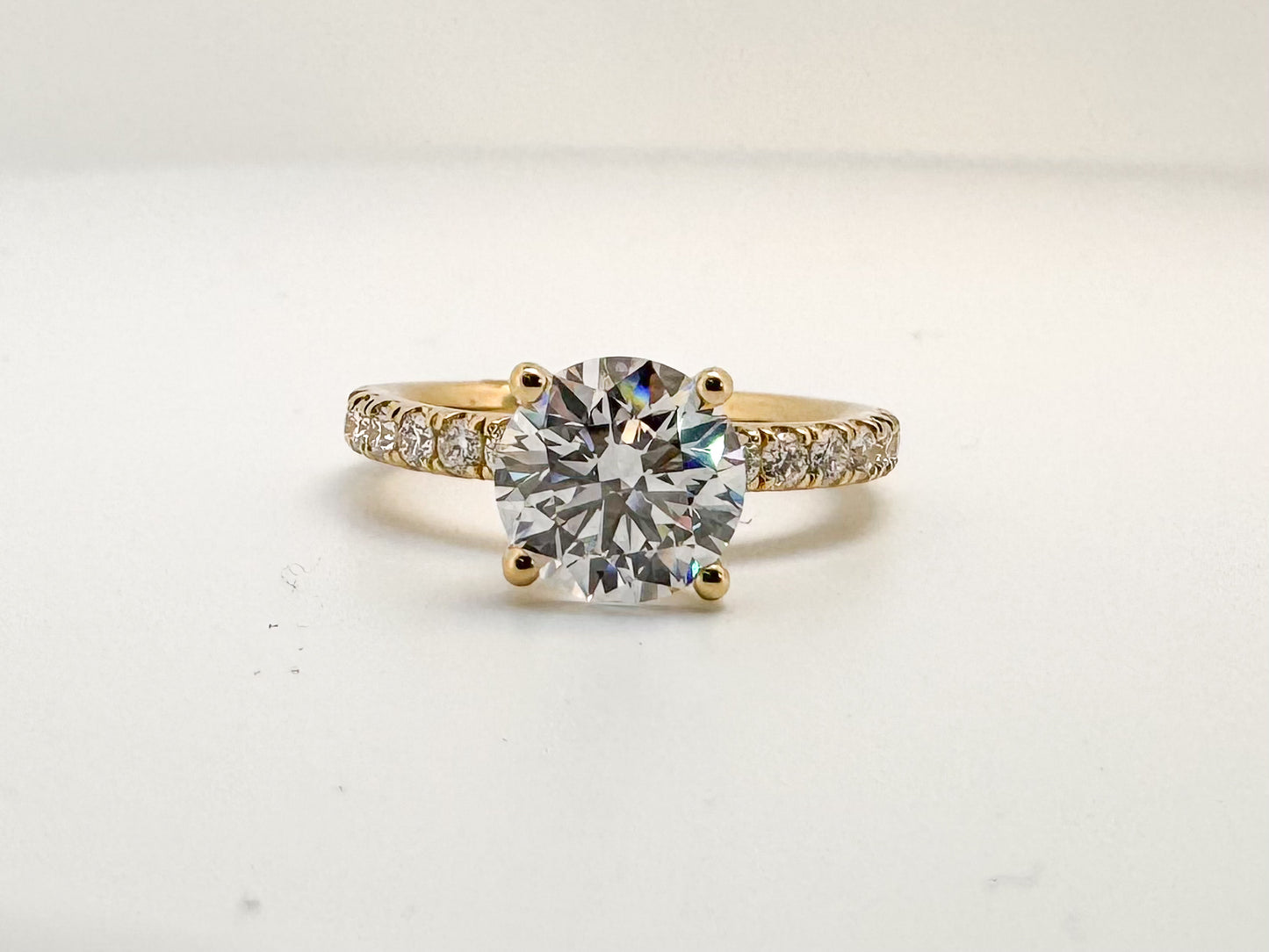 14K, Yellow gold, 2.01 lab grown round brilliant VS1 F, set with .49 side diamonds. IGI certified