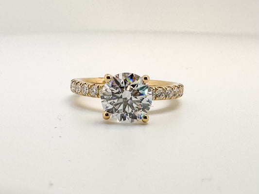 14K, Yellow gold, 2.01 lab grown round brilliant VS1 F, set with .49 side diamonds. IGI certified