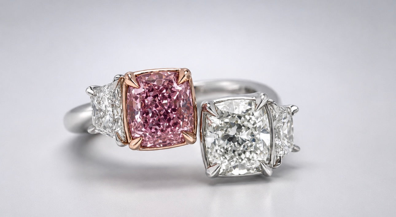 Platinum/ 14k, rose gold 1.09 carat cushion cut fancy pink & 1.03 carat cushion cut VS1 E, .50 side diamonds.