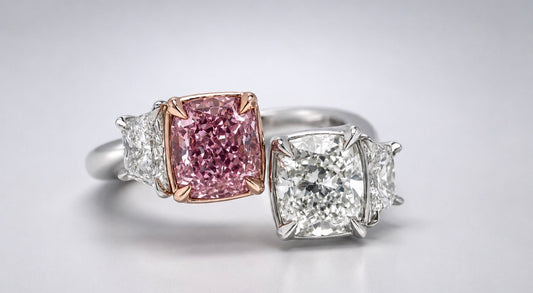 Platinum/ 14k, rose gold 1.09 carat cushion cut fancy pink & 1.03 carat cushion cut VS1 E, .50 side diamonds.