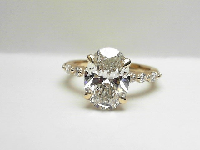 14K, Yellow gold, 3.06 E VS1 lab grown oval center with .37 carats of side diamonds.