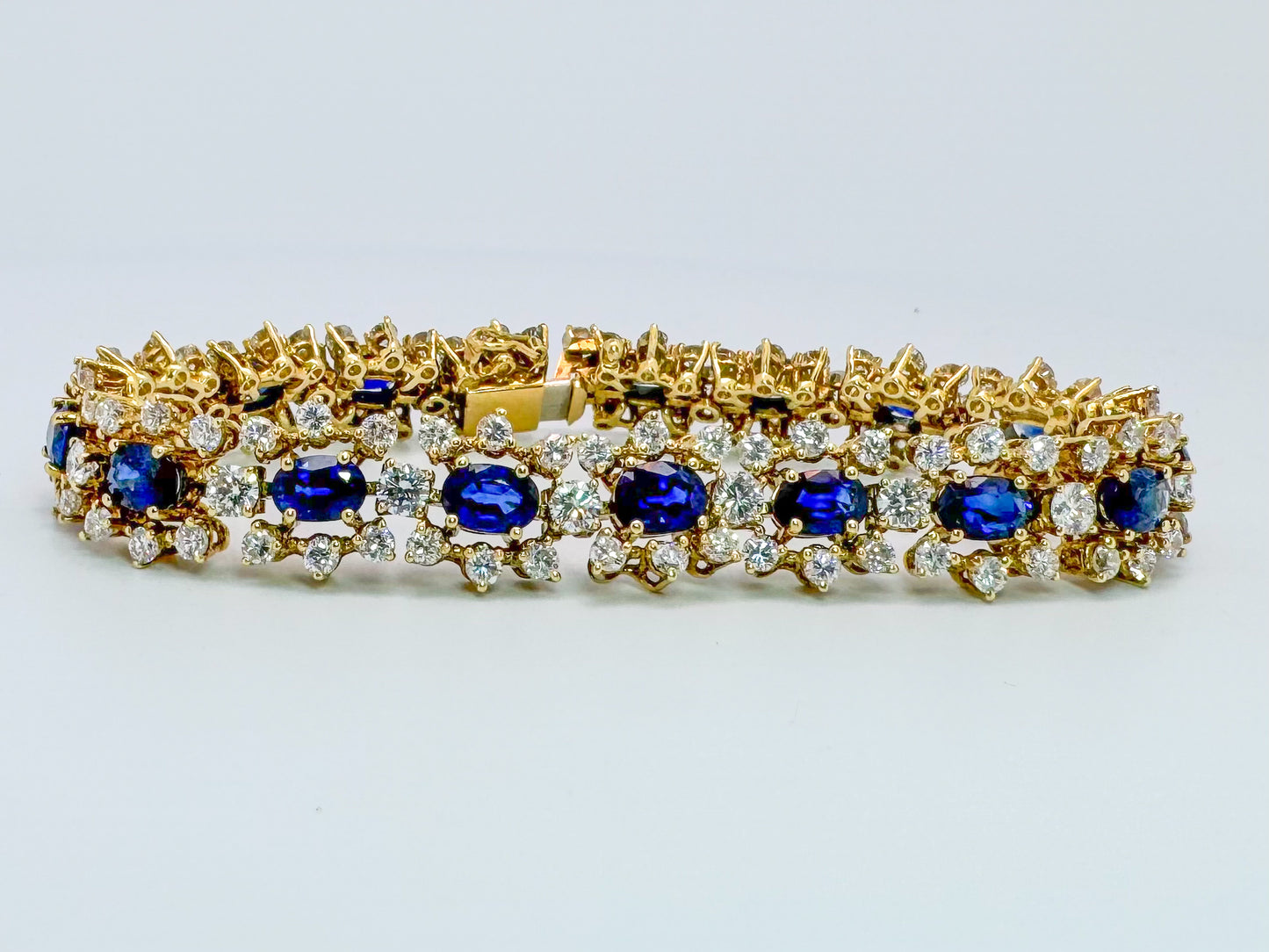 18k, 10.50 carats of natural sapphire surrounded by 9.50 carats of natural diamonds, tennis bracelet.