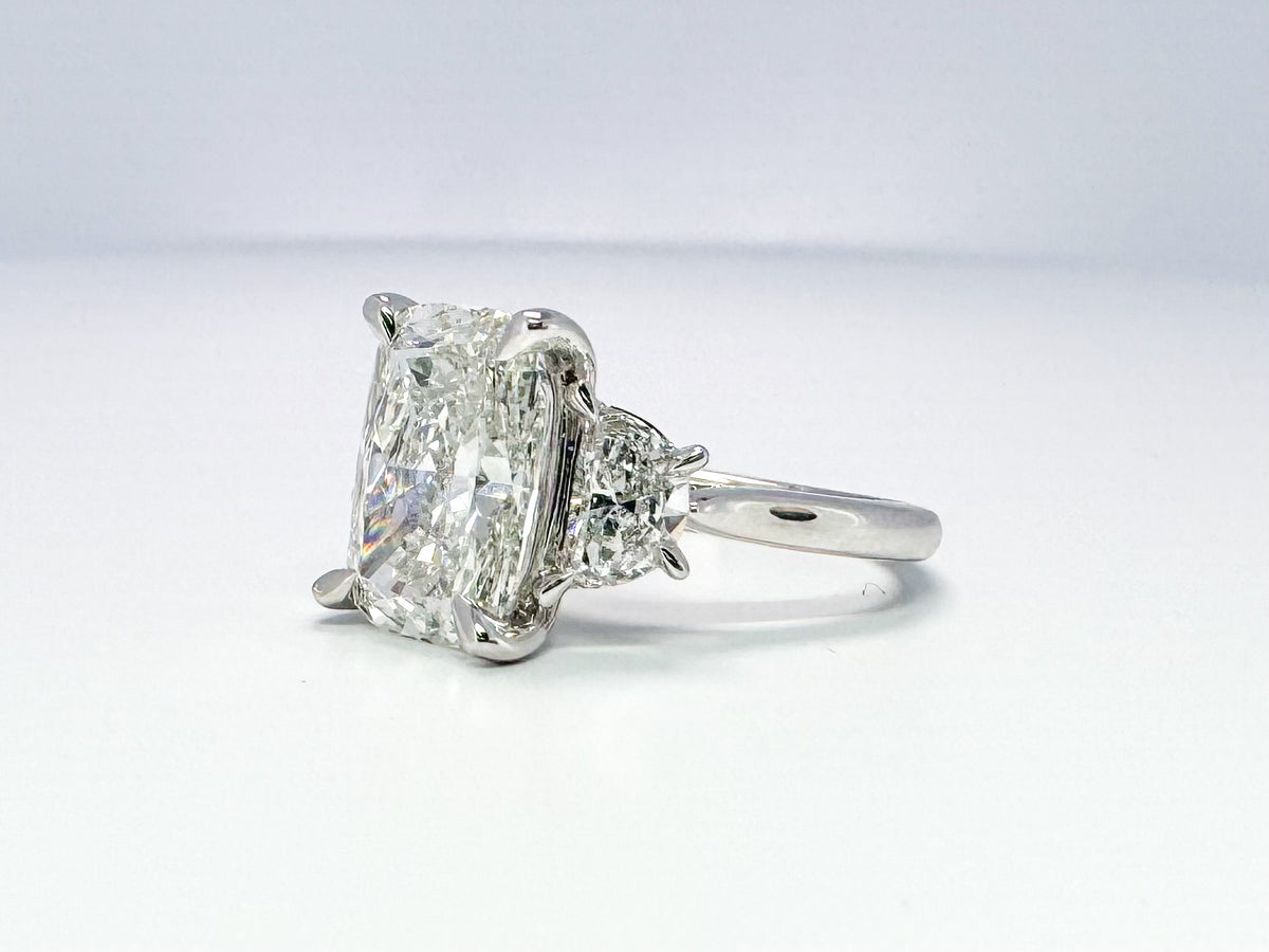 Lab grown 5.09 cushion cut with .90 half moon side diamond engagement ring.