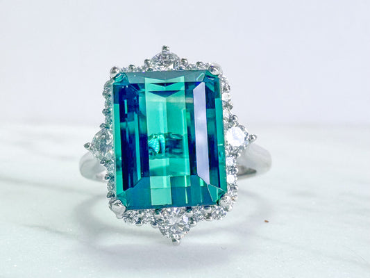 6.33 carat blue green tourmaline with .63 tw side diamond. Set in 14k white gold