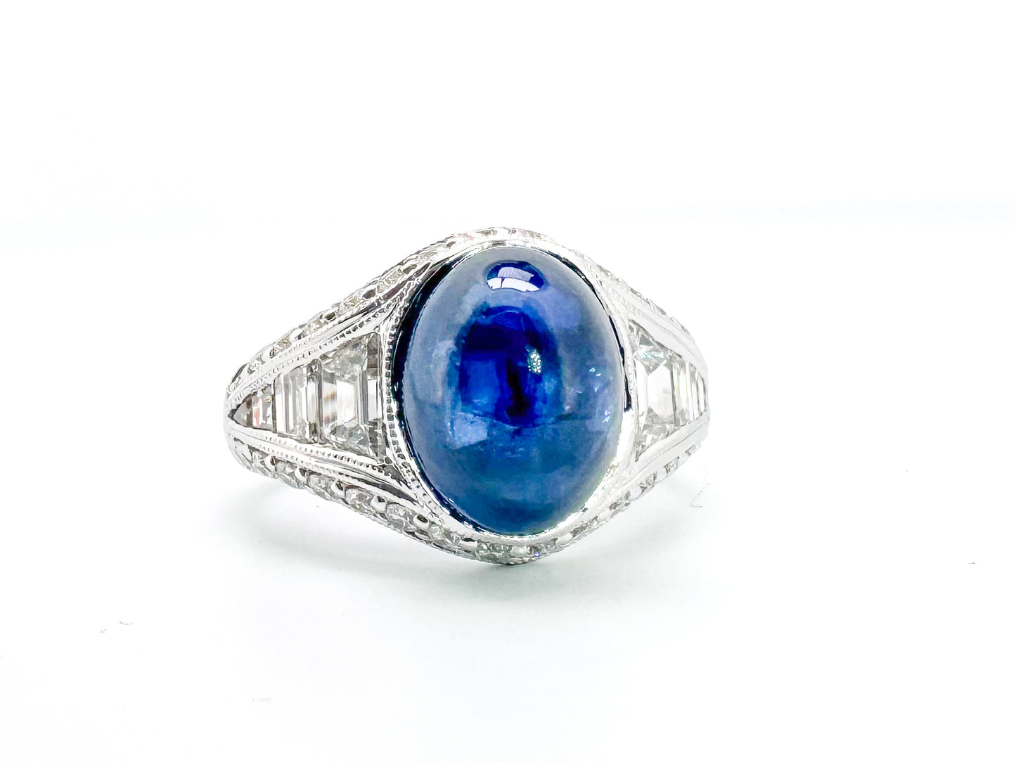 6.27 Carat, natural cabochon sapphire, set in custom hand engraved, 1.60 diamond total weight mounting.