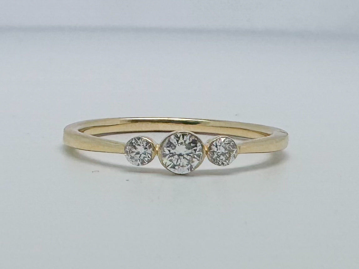 14k yellow gold three stone diamond ring.