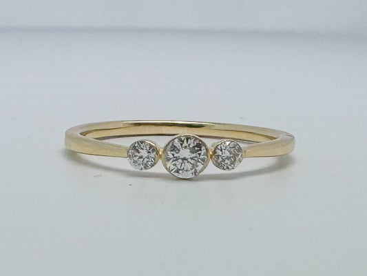 14k yellow gold three stone diamond ring.