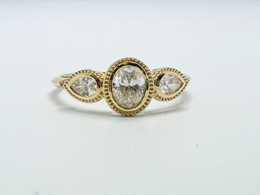 14k yellow gold three stone diamond bezel set ring. .60 carat total weight